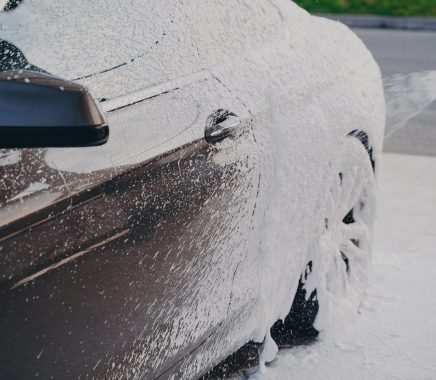 black-luxury-car-in-white-snow-foam-during-car-was-2023-11-27-05-11-31-utc-scaled-qjfhc2tpr3tx6pegwcuolsv6ul5mc440o4jd5ds0rc